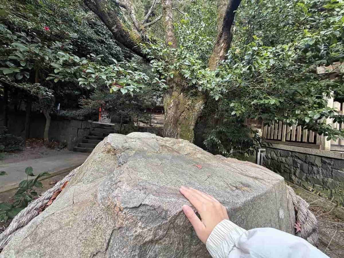 島根県大田市にある『物部神社』の勝石にふれる様子